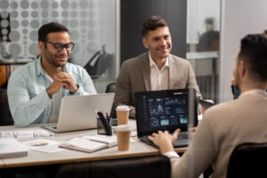 Business team reviewing AI consulting services strategy with data dashboards