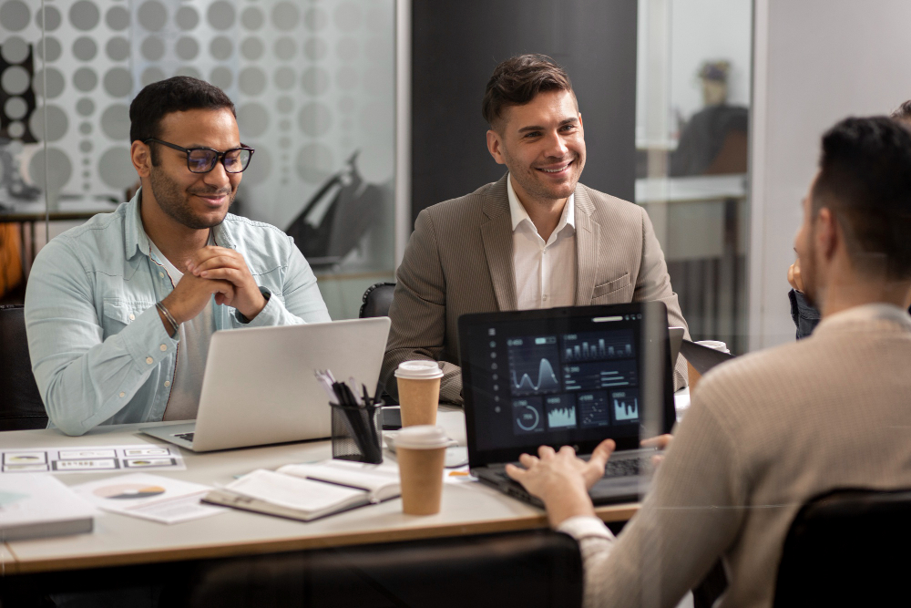 Business team reviewing AI consulting services strategy with data dashboards