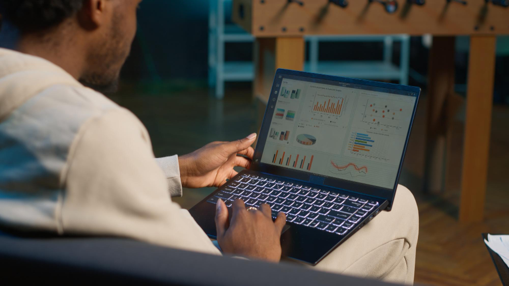 Data scientist reviewing machine learning model results on a laptop in an office setting